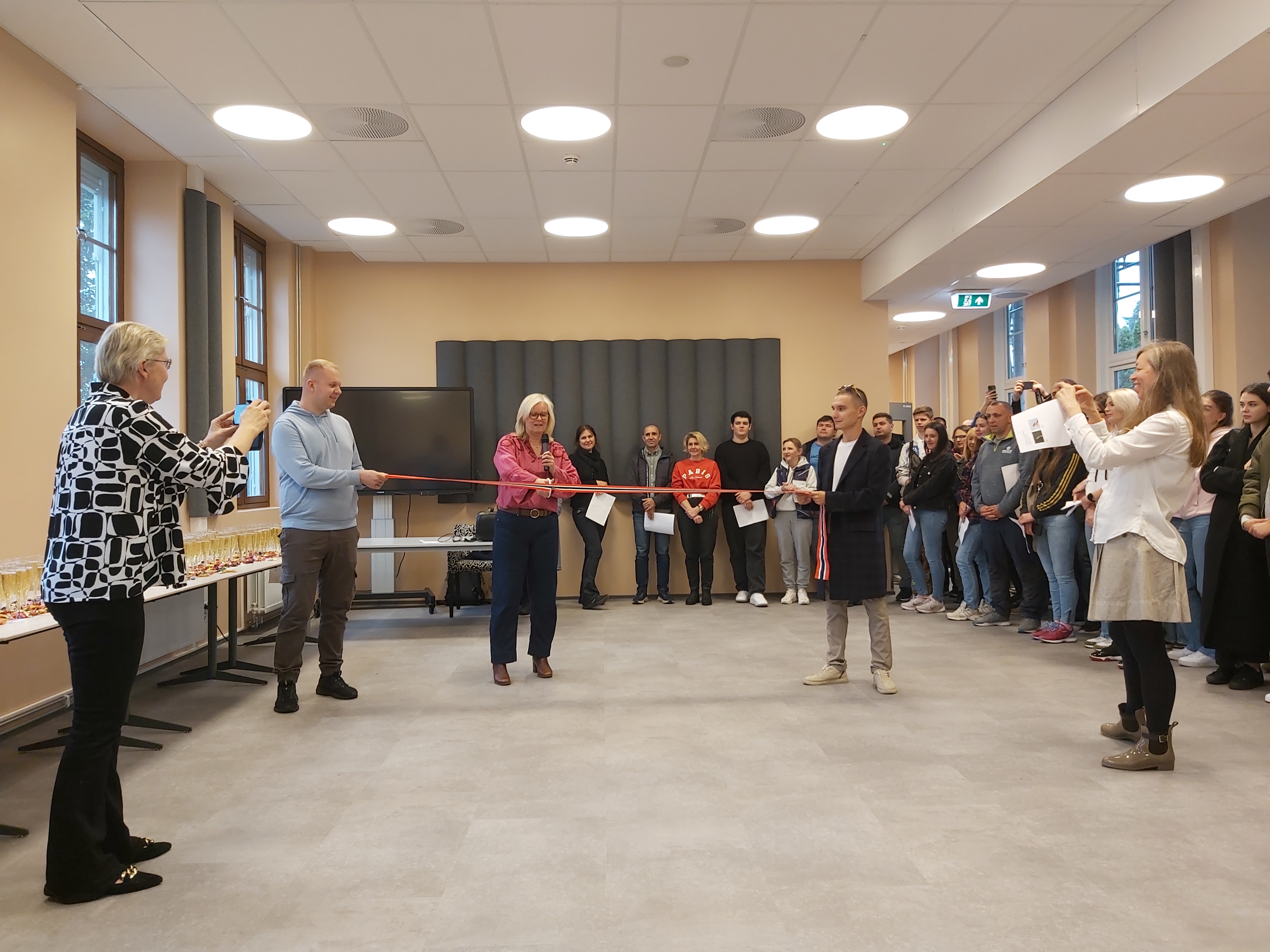 en gruppe mennesker som står i et rom